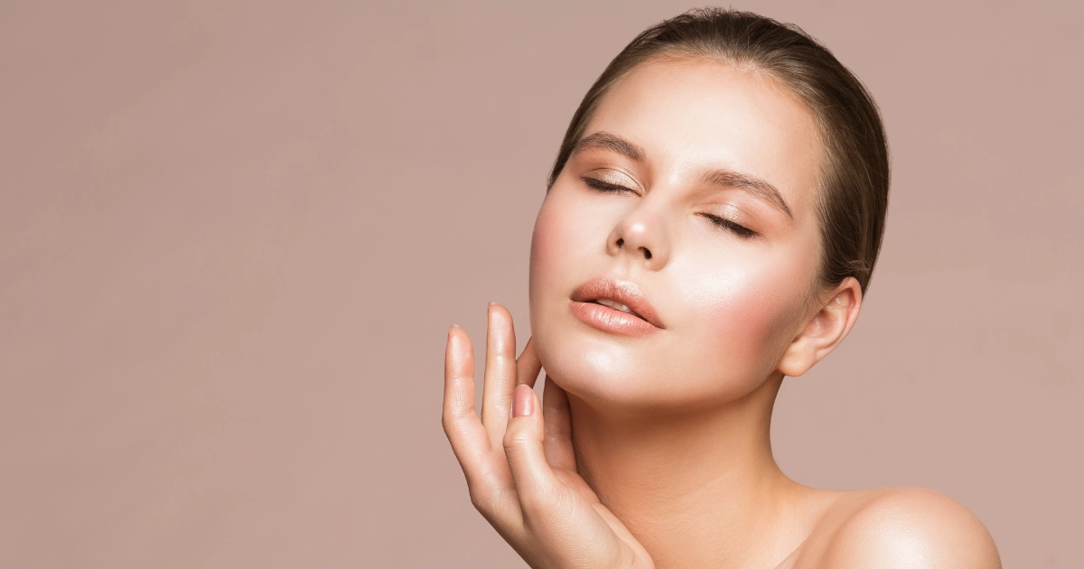 Woman with glowing skin touches neck after Laser Ablative Skin Resurfacing Treatment in Great Falls, MT